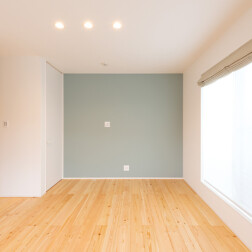 寝室。一面のクロスはTRETTIOカラーのブルーグレー色。落ち着いた空間ができました。寝室には、大容量の収納ができるWICスペースもあります。